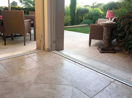 Overgang fra inde til ude med beige-brun travertin