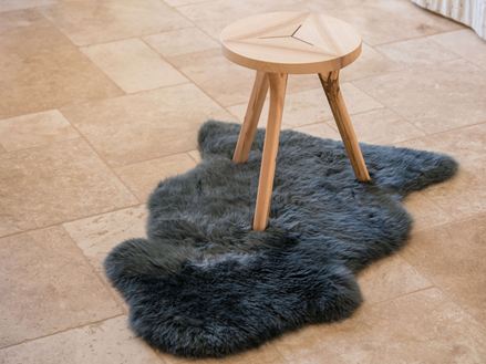 Fliser i travertin med trebenet træskammel